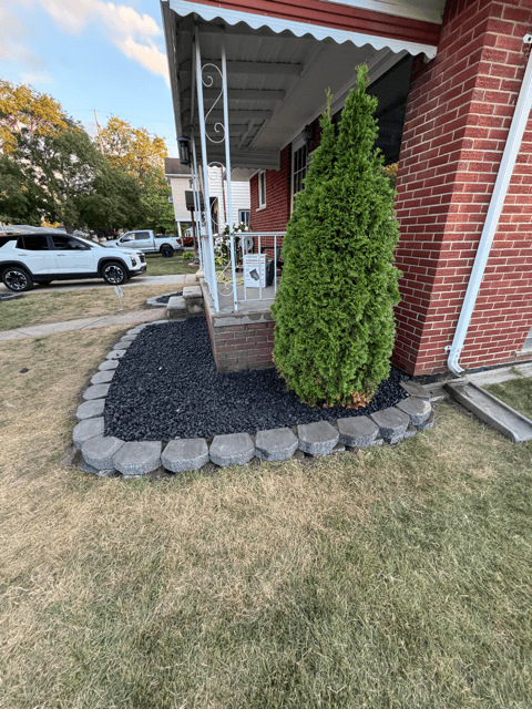 Black rock landscaping bed installed by Heights Yard Solutions